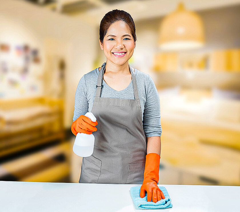 asian housewife sweeping on table