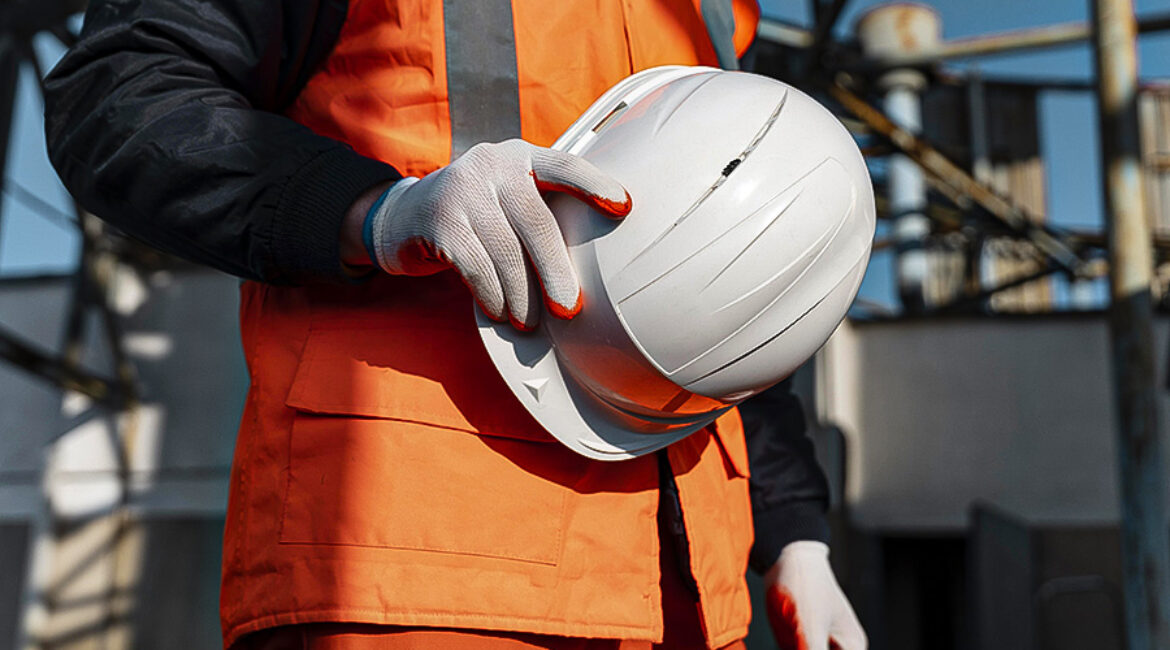 close-up-hand-holding-safety-helmet